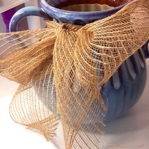 Blue pottery vase with ribbon